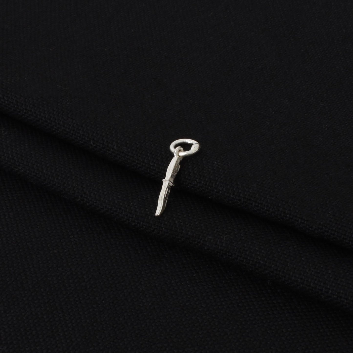 Charming silver pendant showcasing a stylish knife motif