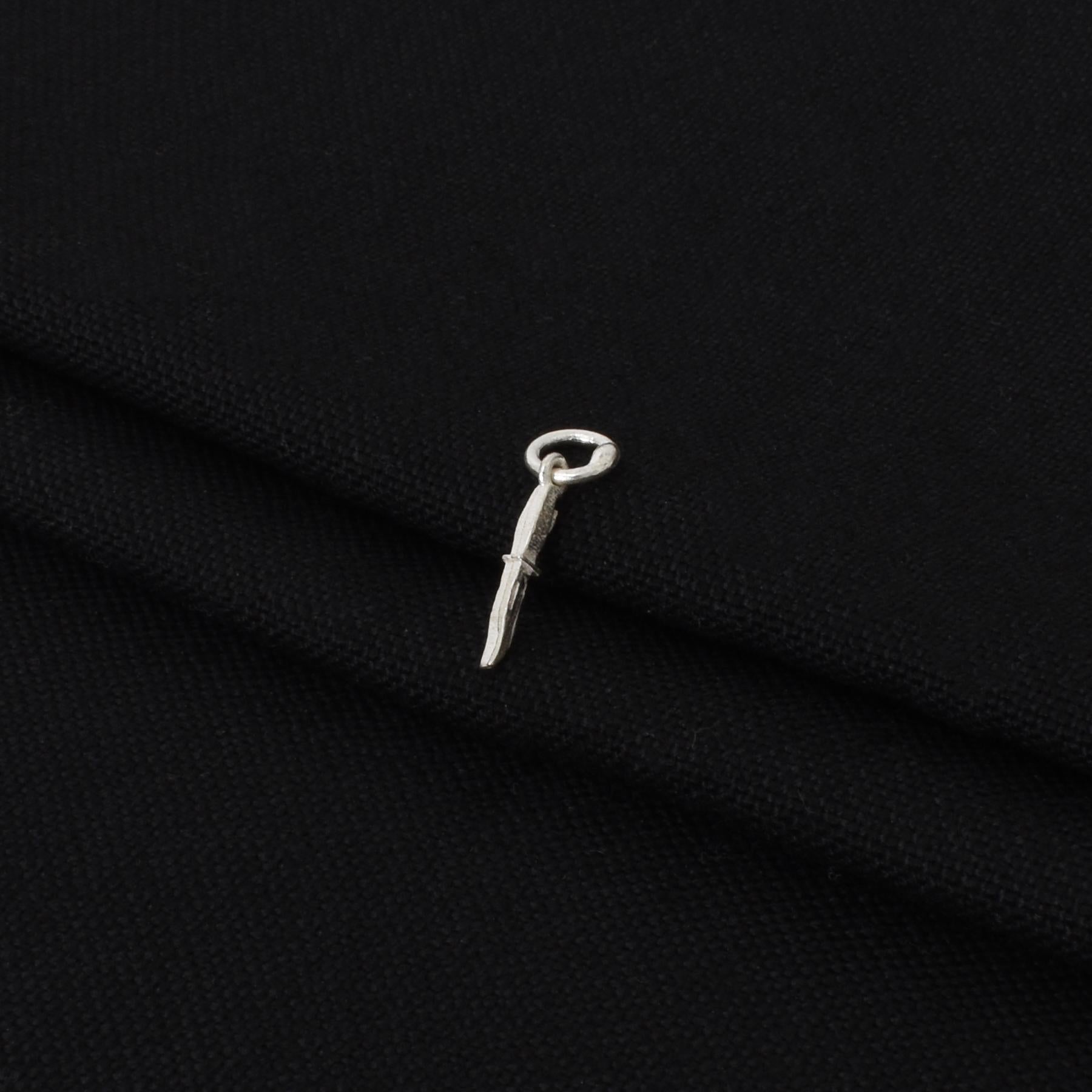 Charming silver pendant showcasing a stylish knife motif