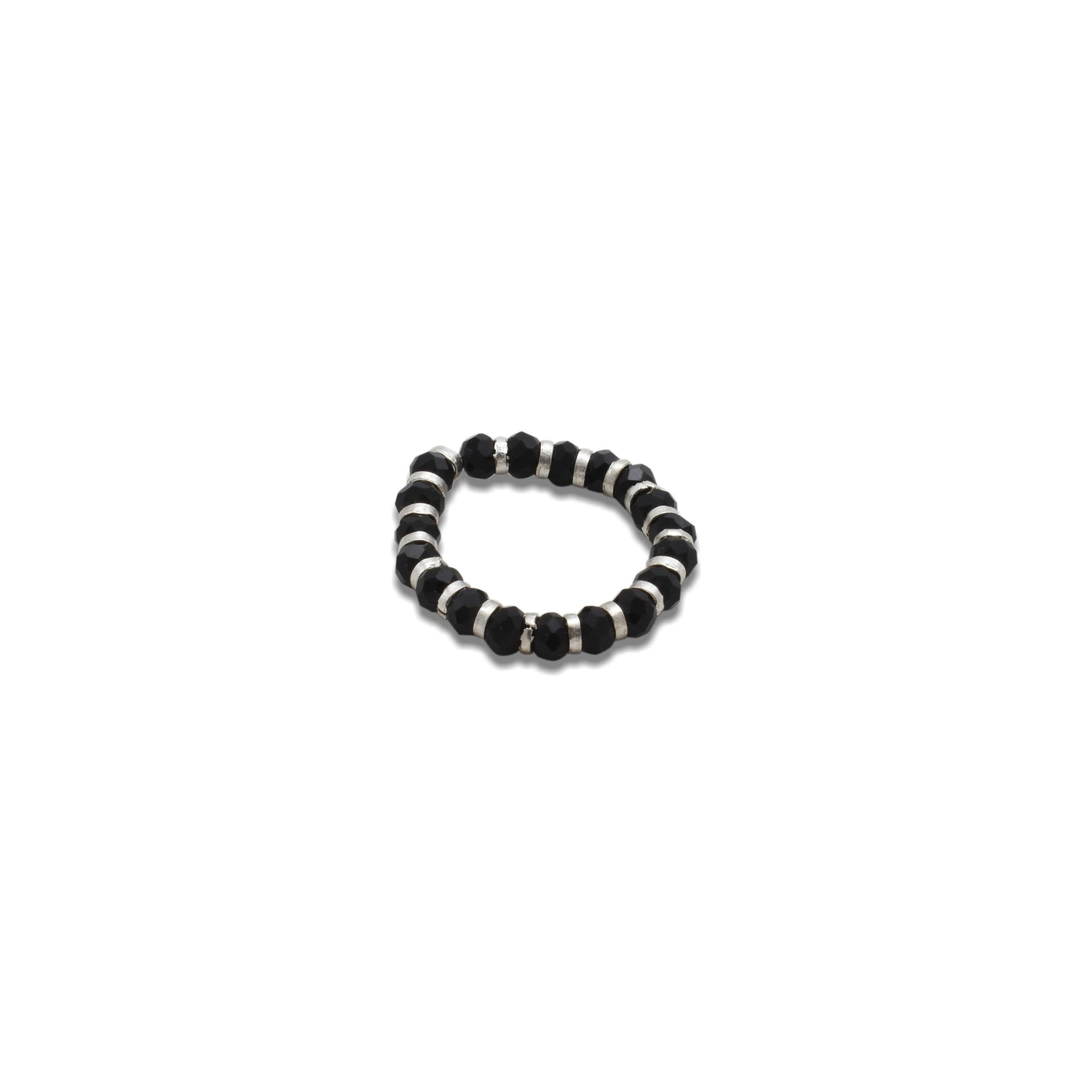 Close-up of a silver ring adorned with black beads, creating a bold and unique chain design