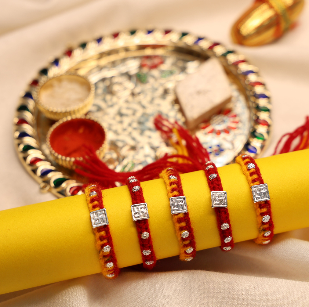 Swastik Glow Silver Rakhi Edition