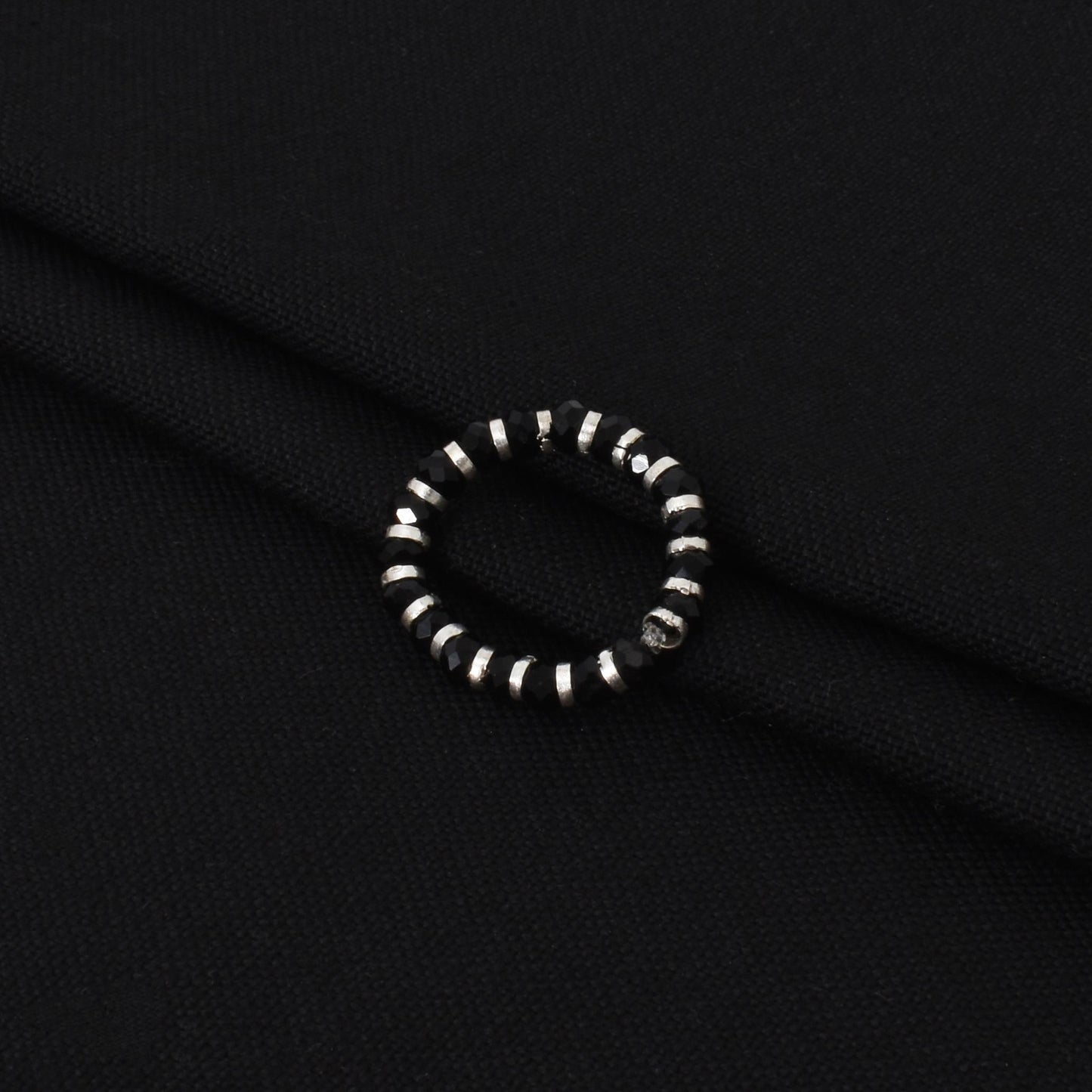 Stylish silver ring with a black beads chain, perfect for adding an edgy touch to any outfit.