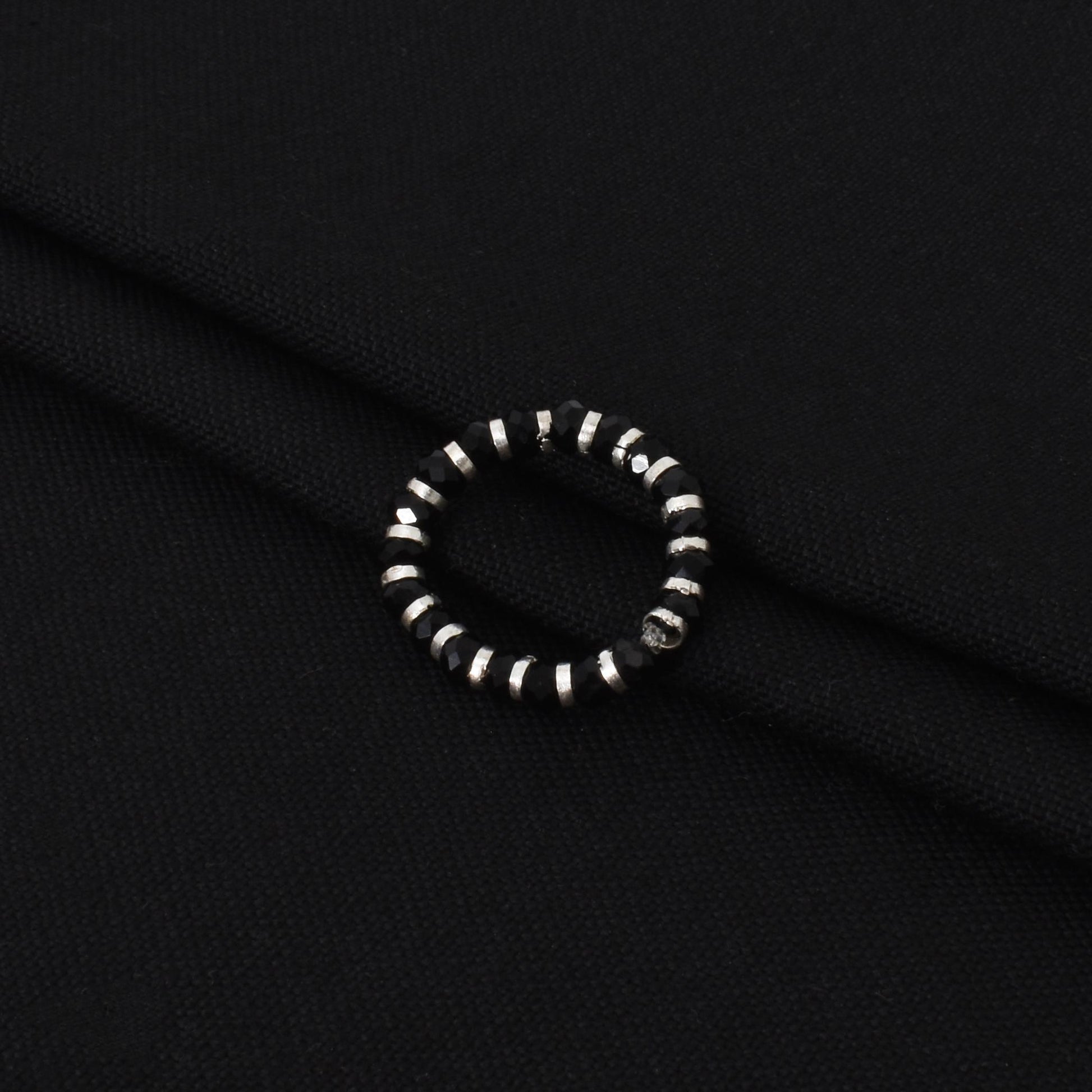 Stylish silver ring with a black beads chain, perfect for adding an edgy touch to any outfit.